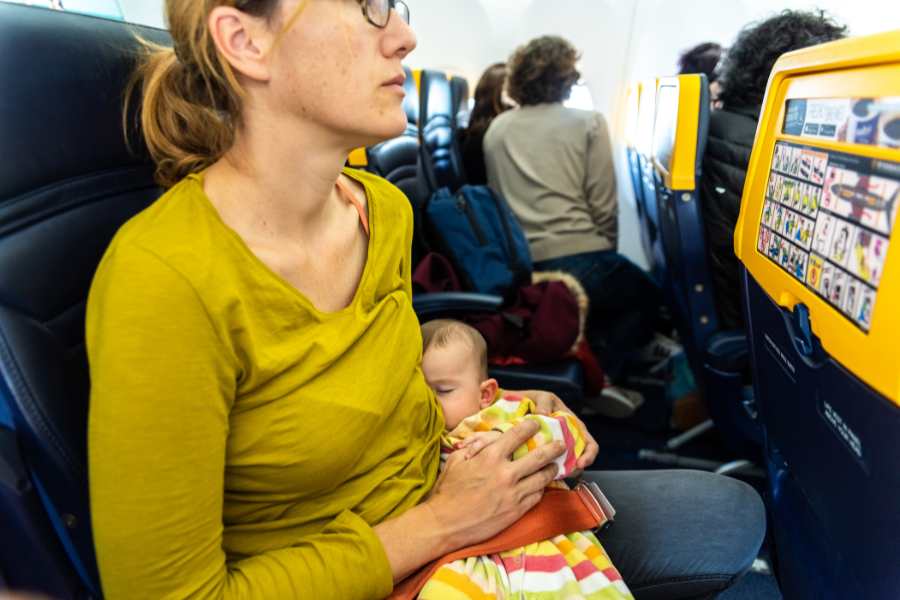 What should I do if I need to change my baby's diaper during the flight